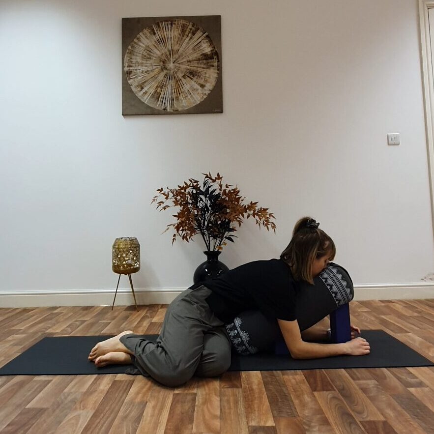 Zoe in a restorative yoga pose
